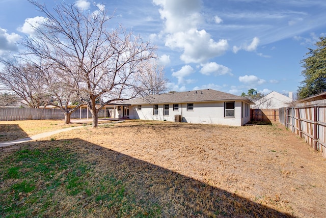 rear view of property with a lawn