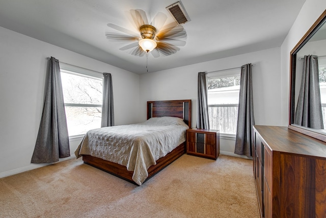 bedroom featuring light colored carpet and ceiling fan