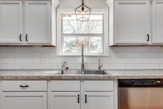 kitchen with sink, decorative backsplash, white cabinets, decorative light fixtures, and stainless steel dishwasher