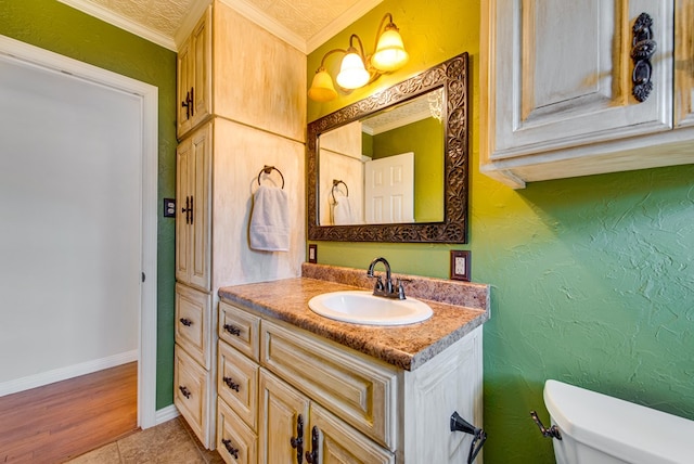 bathroom with vanity, crown molding, and toilet