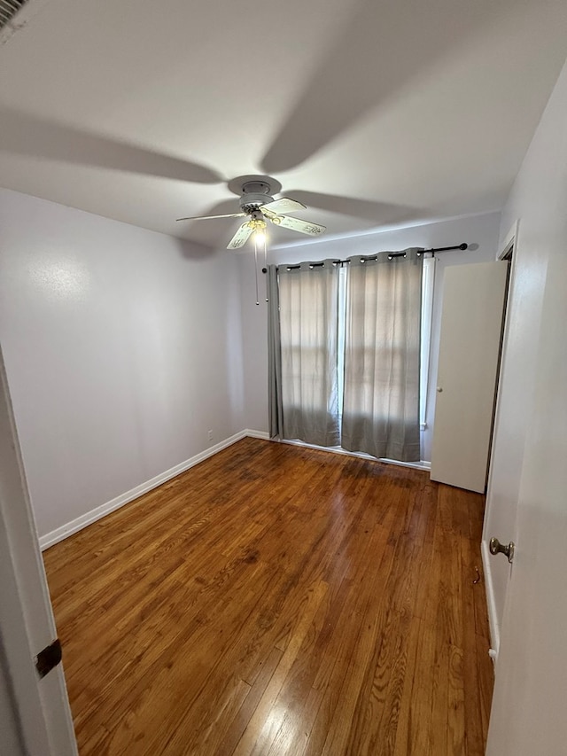 unfurnished room featuring ceiling fan and hardwood / wood-style flooring