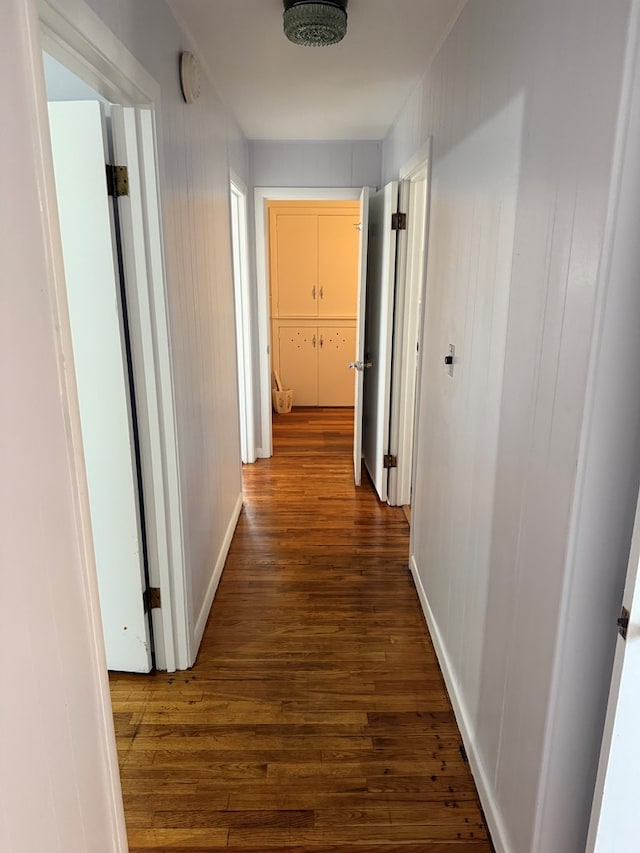 hall with dark wood-type flooring