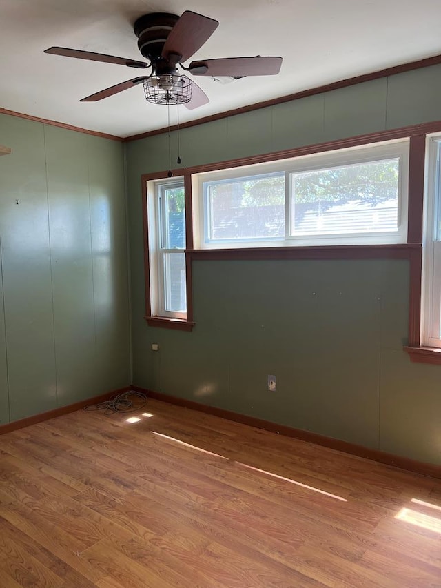 3702 Rose Cir, Snyder, TX 79549 - empty room with ornamental molding, baseboards, a ceiling fan, and wood finished floors