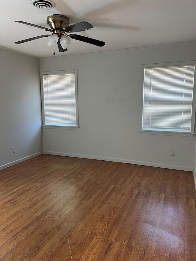 3702 Rose Cir, Snyder, TX 79549 - unfurnished room featuring wood finished floors, visible vents, ceiling fan, and plenty of natural light