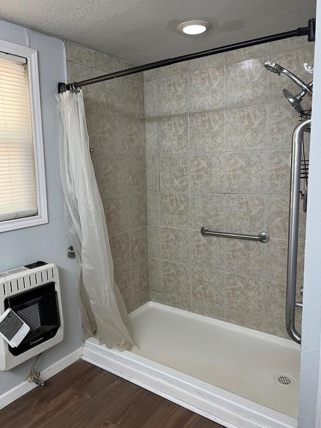 3702 Rose Cir, Snyder, TX 79549 - full bathroom with a shower stall, baseboards, wood finished floors, and heating unit