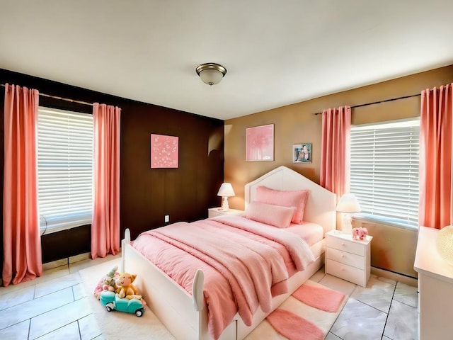 tiled bedroom featuring multiple windows