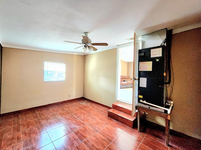 unfurnished room featuring ceiling fan and crown molding