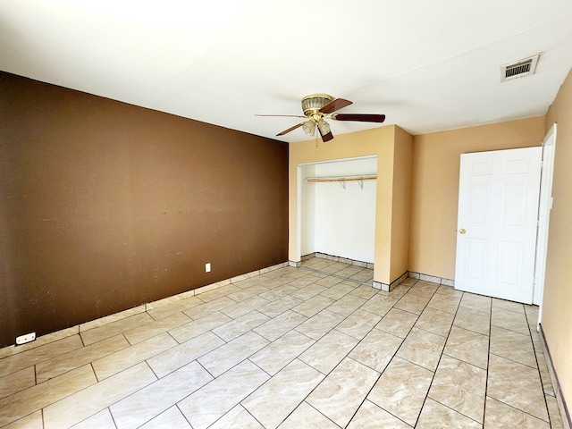 unfurnished bedroom with a closet and ceiling fan