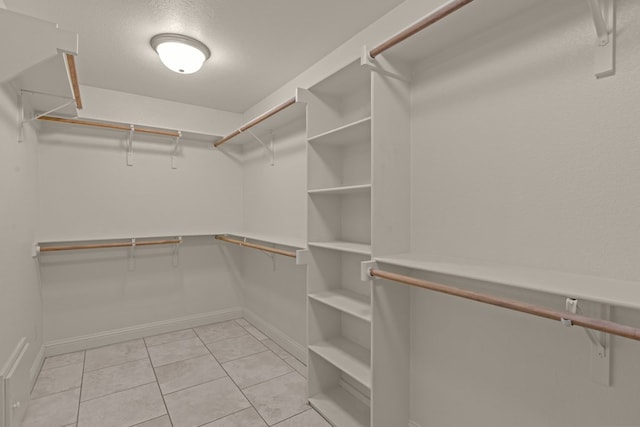 spacious closet featuring light tile patterned floors