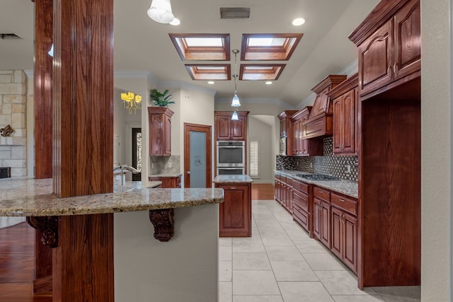 kitchen with crown molding, decorative backsplash, a peninsula, light tile patterned floors, and light stone counters