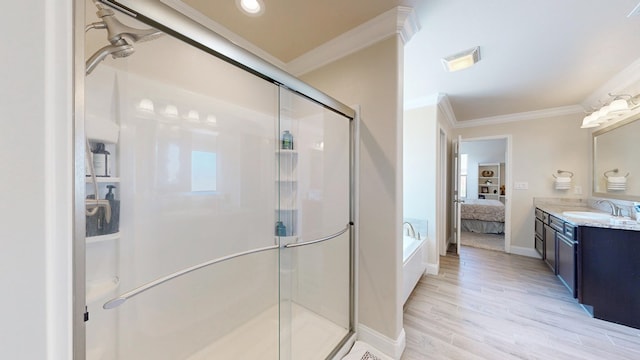 bathroom with a stall shower, ensuite bathroom, wood finished floors, crown molding, and vanity