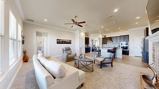 living room featuring visible vents, crown molding, and baseboards