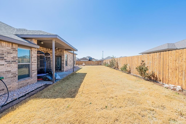 view of yard featuring a patio area and a fenced backyard