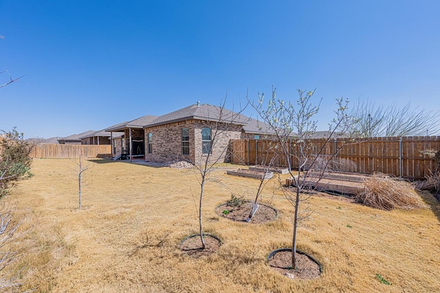 view of yard with a vegetable garden and a fenced backyard