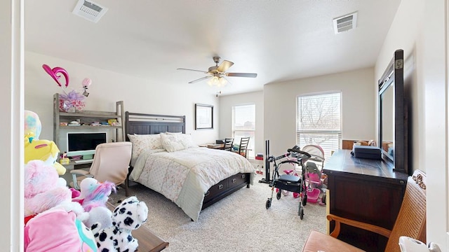 carpeted bedroom featuring visible vents and a ceiling fan