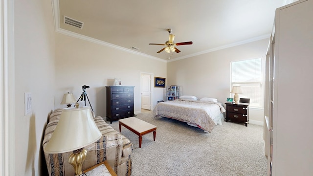 carpeted bedroom with visible vents, ornamental molding, and a ceiling fan