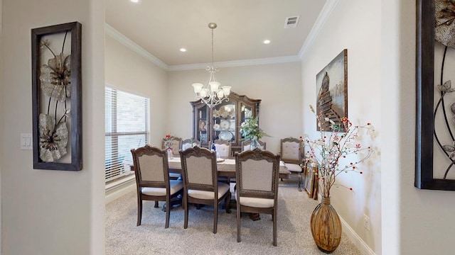 dining room with baseboards, visible vents, ornamental molding, carpet flooring, and a chandelier