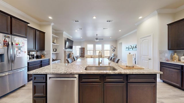 kitchen featuring an island with sink, visible vents, appliances with stainless steel finishes, and a sink