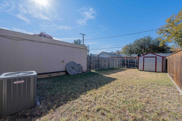 view of yard featuring central air condition unit and a storage unit