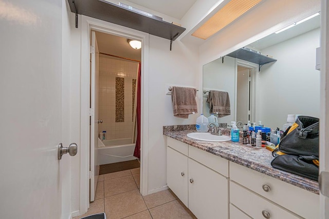 bathroom featuring tile patterned flooring, vanity, and shower / bath combo