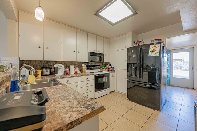 kitchen featuring white cabinetry, sink, hanging light fixtures, light tile patterned flooring, and black appliances