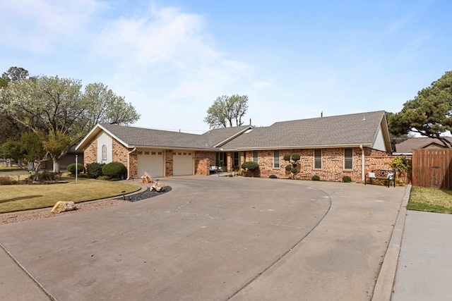 6413 Piedmont Dr, Odessa, TX 79762 - single story home with curved driveway, a front lawn, an attached garage, brick siding, and fence