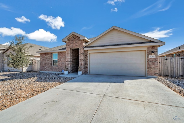 ranch-style house with a garage, brick siding, driveway, and fence