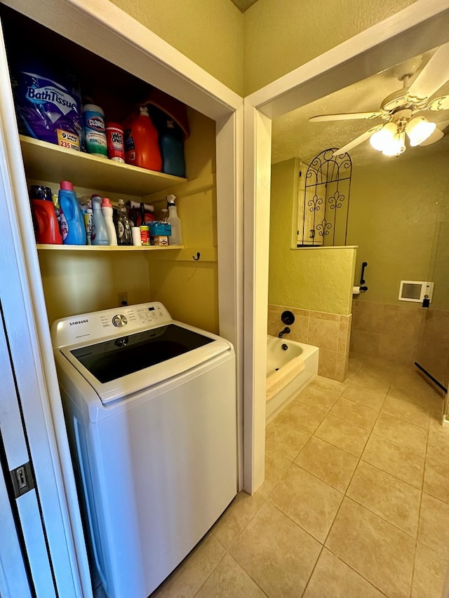 clothes washing area featuring light tile patterned floors, laundry area, washer / dryer, and a ceiling fan