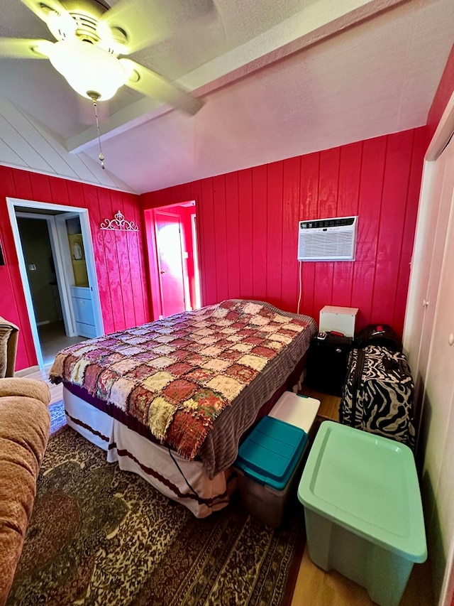 bedroom featuring vaulted ceiling with beams, wood walls, wood finished floors, and a wall mounted air conditioner