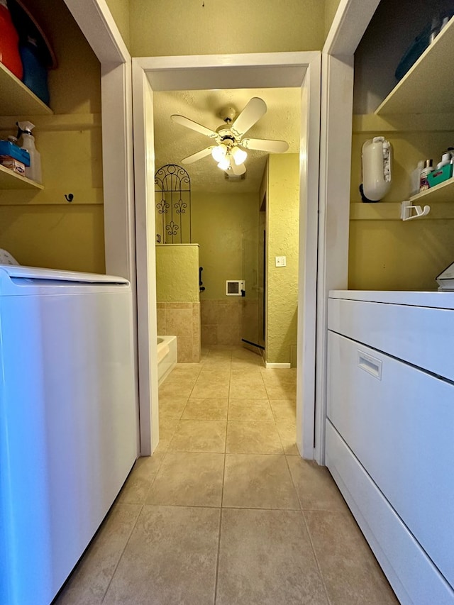 interior space with washer / dryer, ceiling fan, a textured ceiling, and tile patterned floors