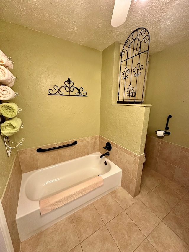 bathroom featuring a textured ceiling, tile walls, a bath, and tile patterned floors