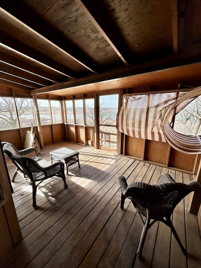 sunroom featuring beamed ceiling