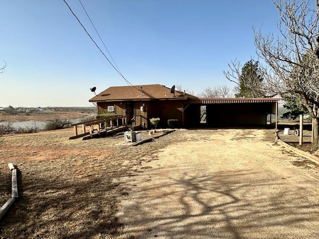 single story home featuring driveway and a carport