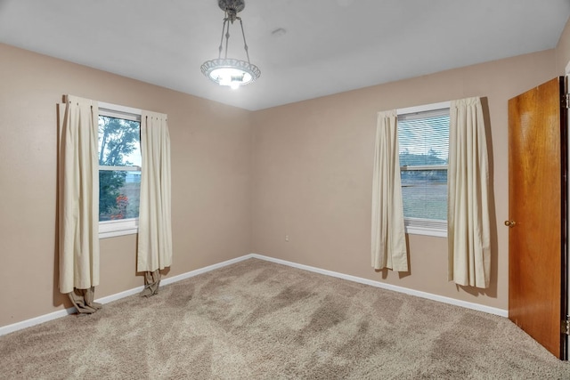 116 W Robinson Rd, Big Spring, TX 79720 - empty room with healthy amount of natural light, carpet, and baseboards