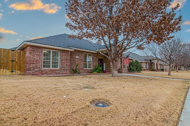 ranch-style home featuring a front yard