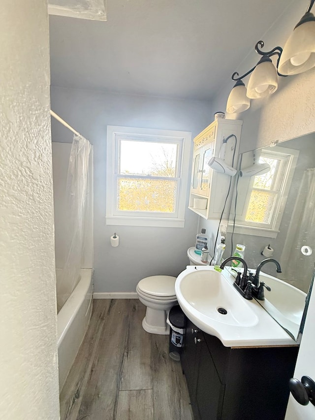 full bathroom featuring shower / bath combination with curtain, wood-type flooring, vanity, and toilet