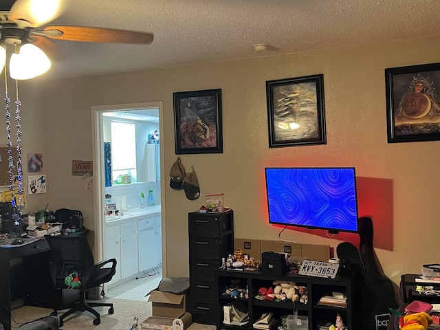 home office with ceiling fan and a textured ceiling