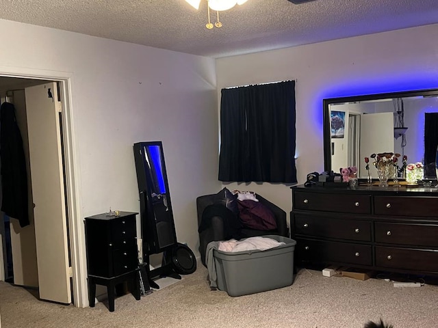 bedroom with carpet floors and a textured ceiling