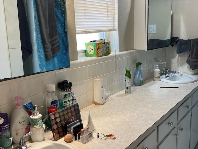 bathroom with vanity and decorative backsplash