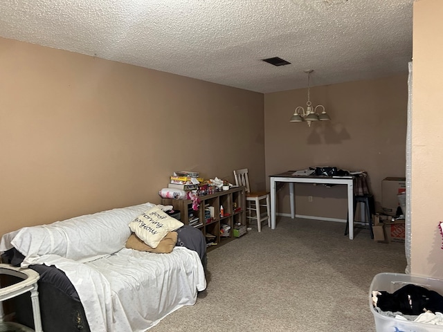 rec room with a textured ceiling, a chandelier, and carpet flooring