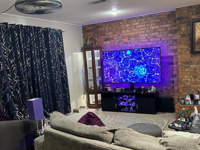 home theater room with brick wall, visible vents, and a textured ceiling