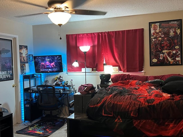 bedroom featuring carpet flooring, ceiling fan, and a textured ceiling