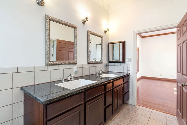 bathroom featuring tasteful backsplash, hardwood / wood-style floors, vanity, and ornamental molding