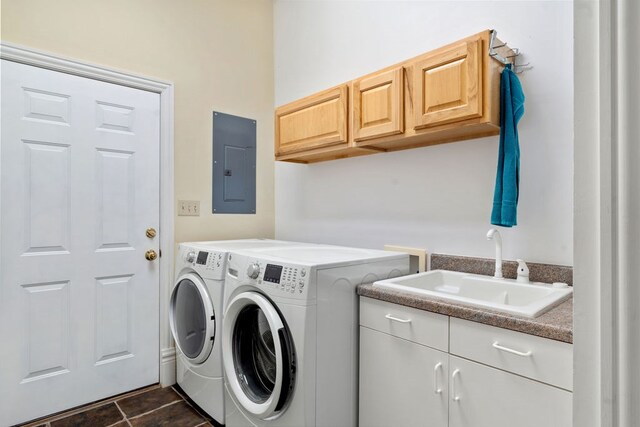 clothes washing area featuring washing machine and dryer, dark tile patterned floors, sink, and electric panel