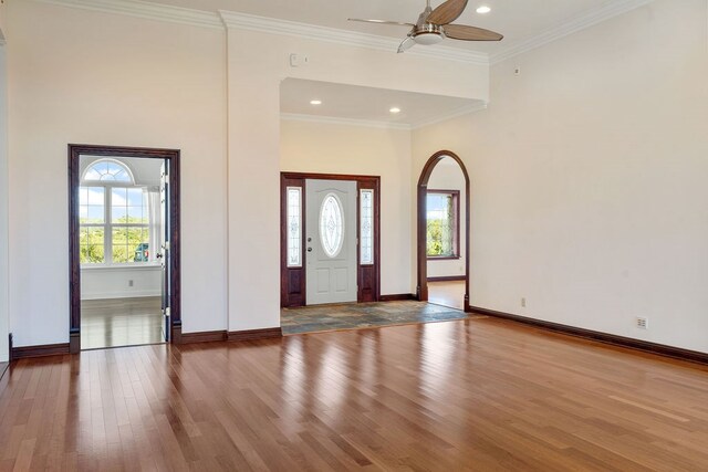 entryway with crown molding, ceiling fan, and hardwood / wood-style flooring