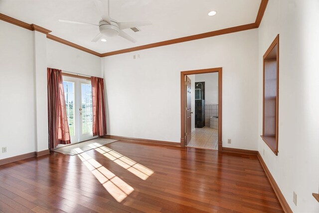 spare room featuring hardwood / wood-style floors, ceiling fan, and ornamental molding