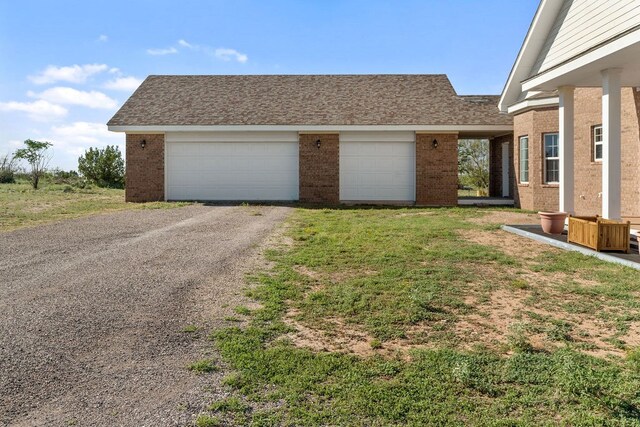 garage featuring a lawn