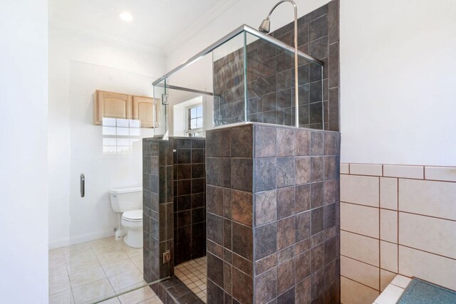 bathroom with a shower with door, tile patterned flooring, toilet, ornamental molding, and tile walls