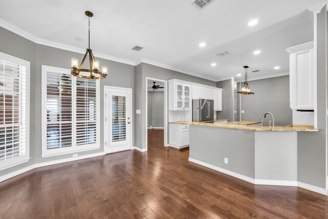2201 Hereford Blvd, Midland, TX 79707 - kitchen with dark wood finished floors, high quality fridge, baseboards, a chandelier, and white cabinetry