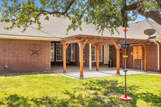 2201 Hereford Blvd, Midland, TX 79707 - back of house featuring a pergola, a yard, and brick siding